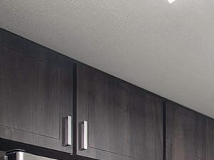 EspressoHomeFinishes-Quartz countertops in newly renovated kitchens Full Rehab Kitchen at Merrick Apartments in Placentia CA